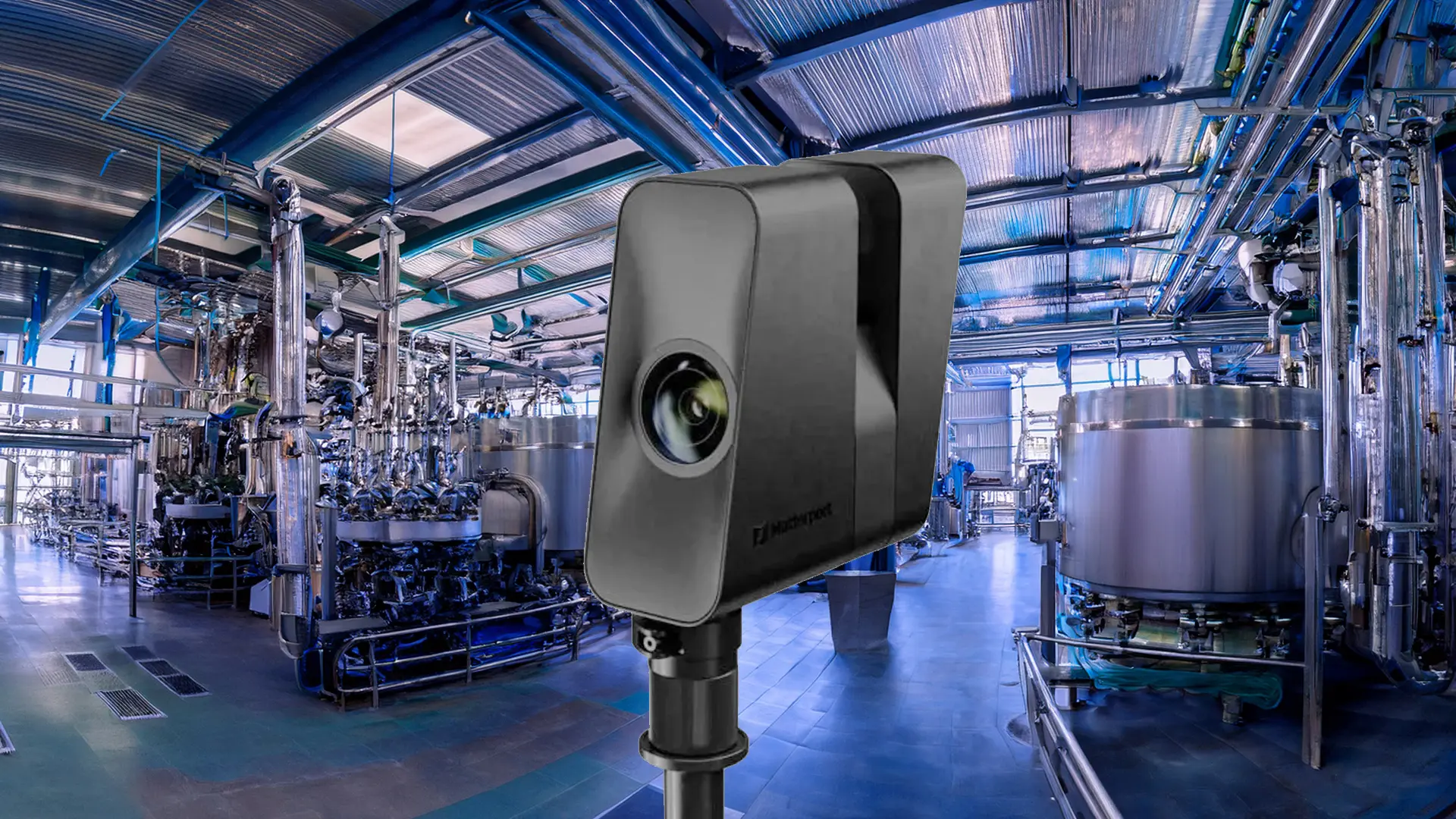 Matterport Pro3 3D scanning camera positioned inside an industrial manufacturing facility with stainless steel tanks and processing equipment.